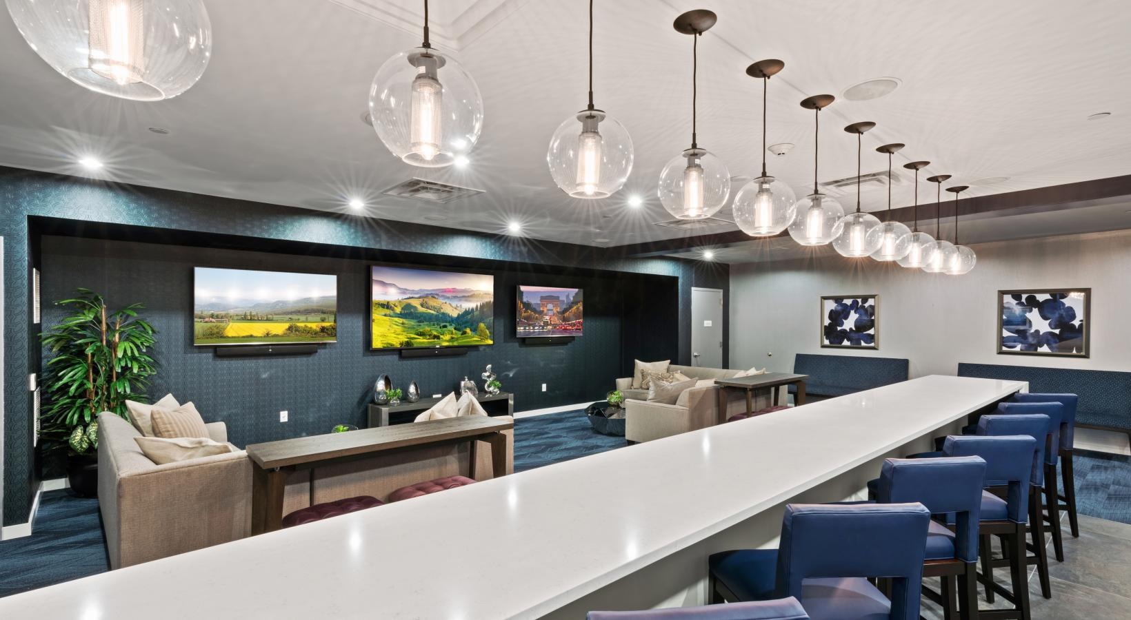 State-of-the-art amenities a room with a bar and chairs