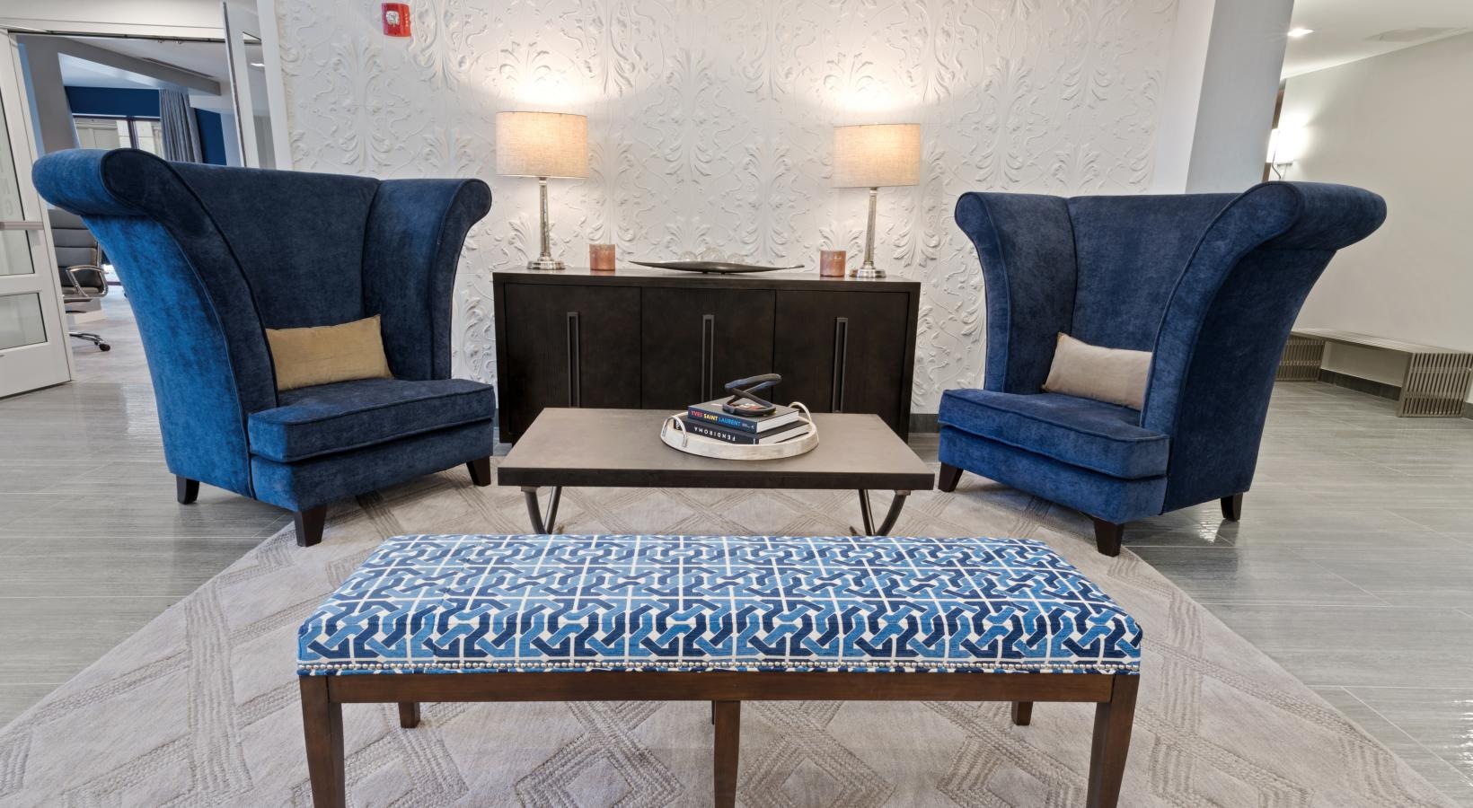 Enjoy our resident-only features a room with blue chairs and a coffee table