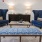 a room with blue chairs and a coffee table