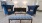 a room with blue chairs and a coffee table