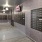 a mail room with grey walls and grey floors