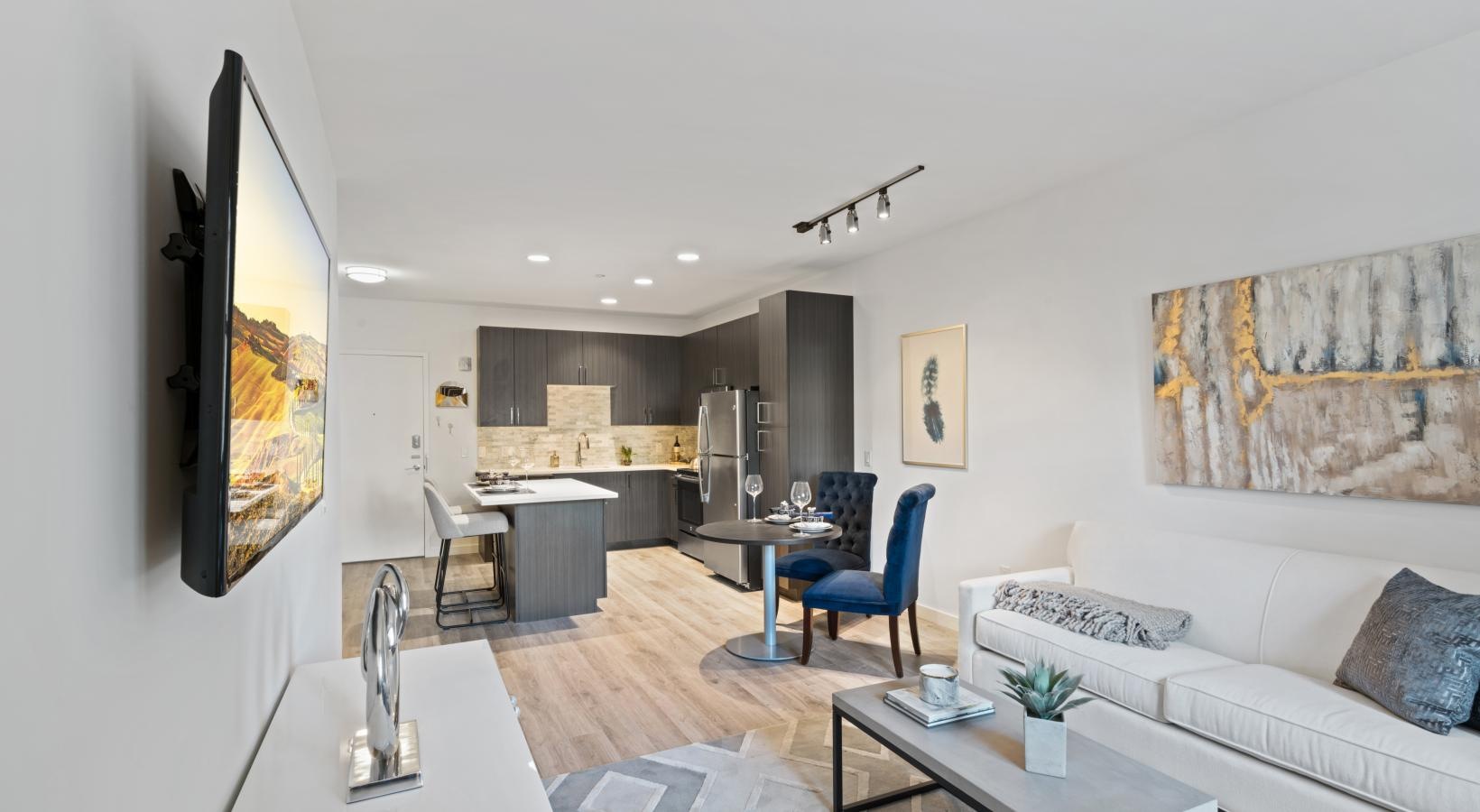 Wide open living areas perfect for entertaining a living room with a couch and a tv