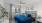 a bedroom with a bed and a plant