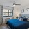a bedroom with a bed and a plant