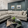 a clubhouse room with a large couch and a plant