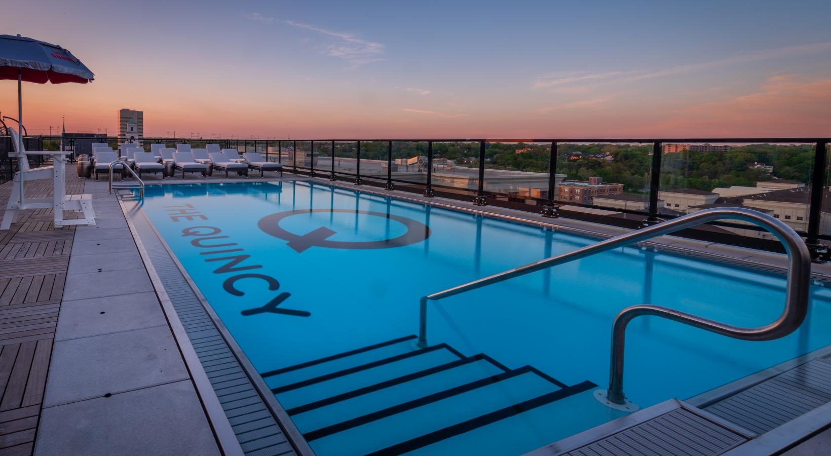 Resort-style swimming pool a pool with a deck and umbrella