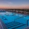 a pool with a deck and umbrella