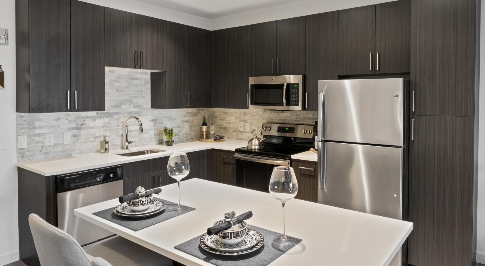 Beautiful living areas to match your lifestyle a kitchen with a table and chairs