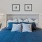 a bed with blue pillows