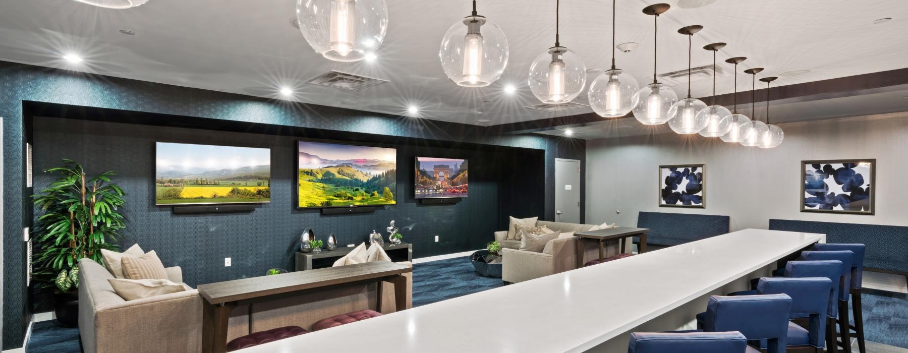 a room with a bar and chairs