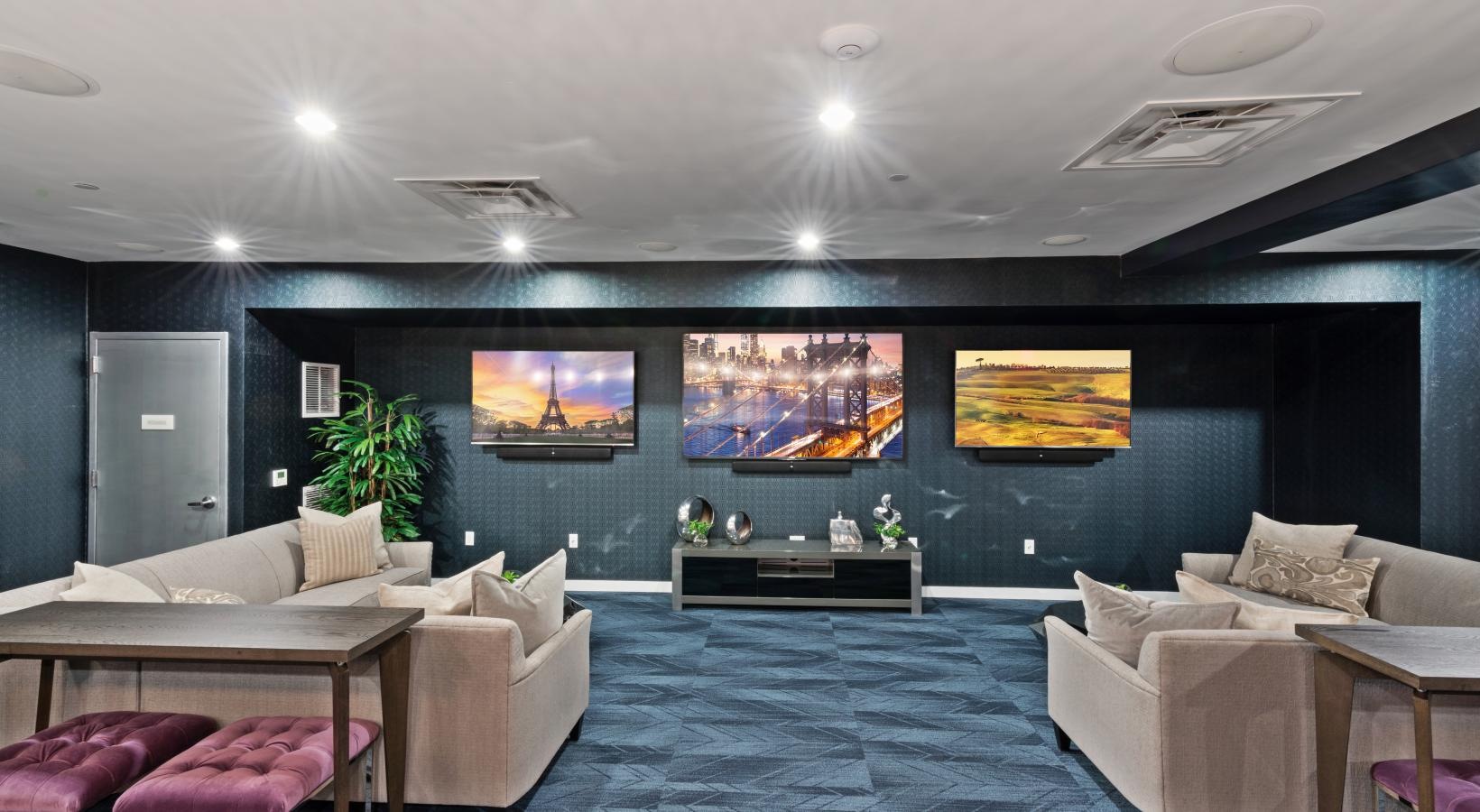 Take advantage of all The Quincy has to offer a room with a large wall of paintings and a couch