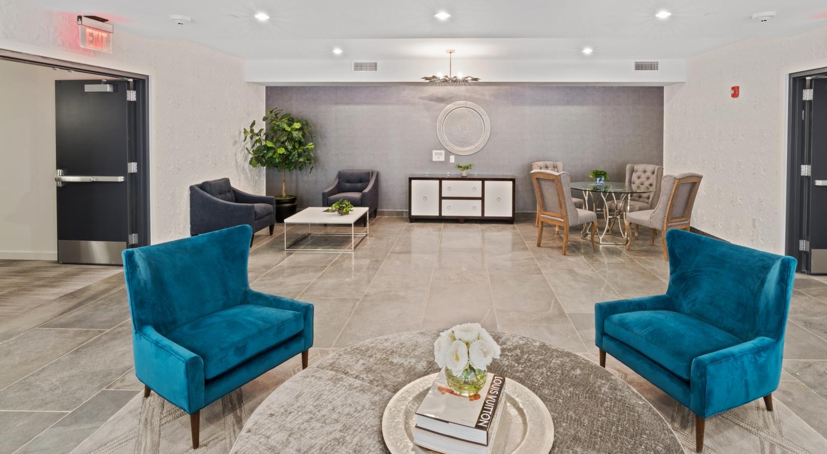 Access to resident-only features a room with blue chairs and a table
