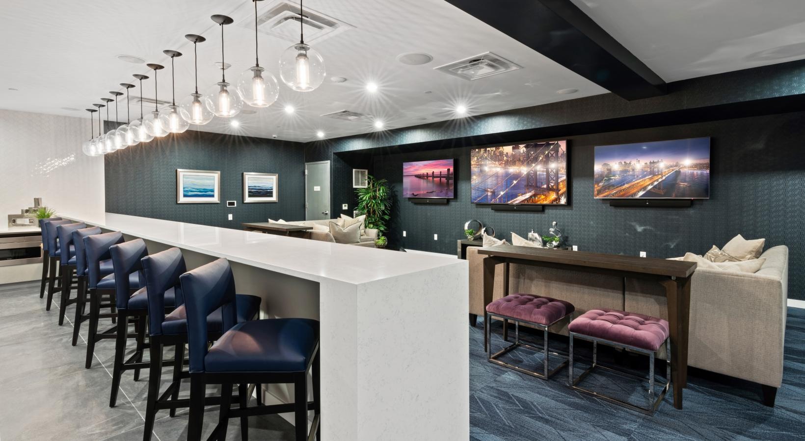 State-of-the-art amenities a room with a bar and chairs