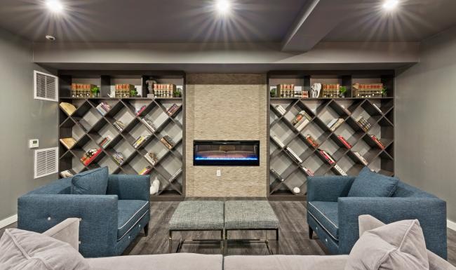 a lounge room with a tv and shelves