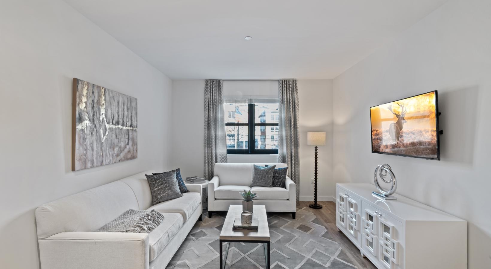Generous living spaces to relax and unwind a living room with a white couch and a white table